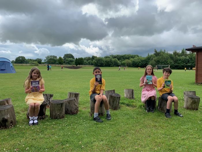 Children reading outdoors